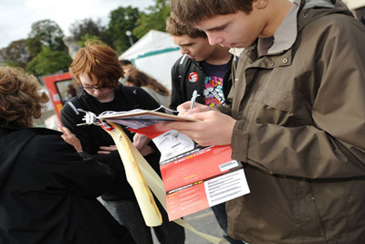 Students collecting signatures for a petition to ban cluster bombs.